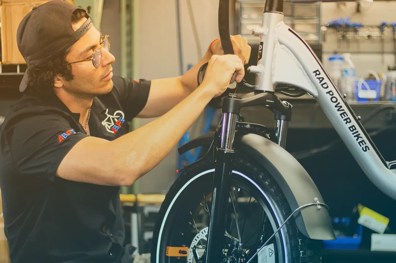 Bike mechanic assembling a RAD ebike. 