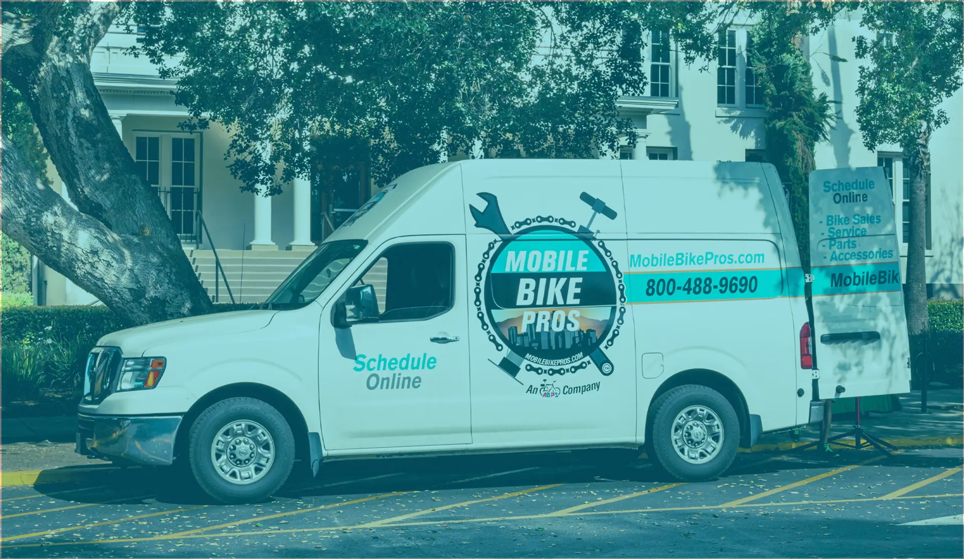 Mobile Bike Pros van servicing at a college campus.